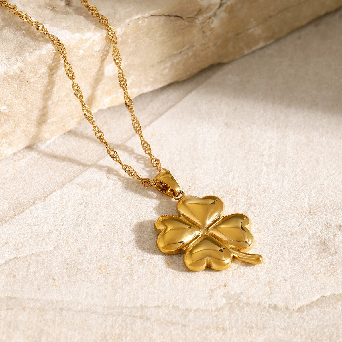 Elegant 18K gold pendant necklace featuring a delicate four-leaf clover design, symbolizing luck and fortune, with a shiny gold finish that adds a touch of luxury and charm.