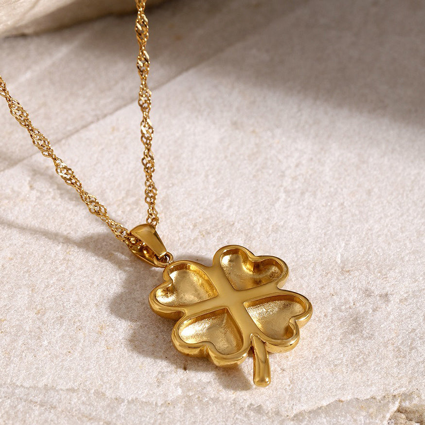 Elegant 18K gold pendant necklace featuring a delicate four-leaf clover design, symbolizing luck and fortune, with a shiny gold finish that adds a touch of luxury and charm.