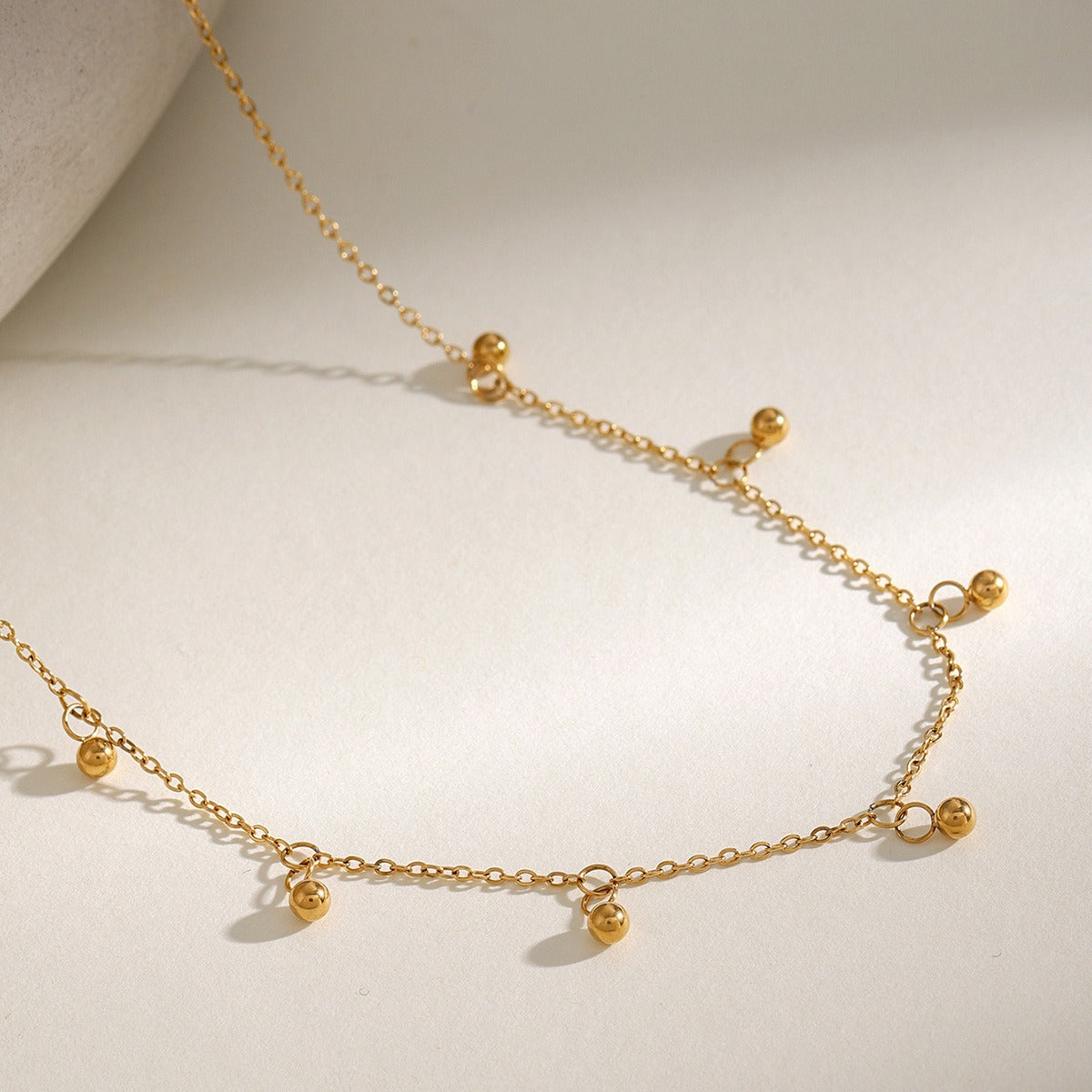 Delicate 18K gold necklace featuring light, round bead design, offering a minimalist and elegant look, perfect for adding a touch of sophistication to any outfit