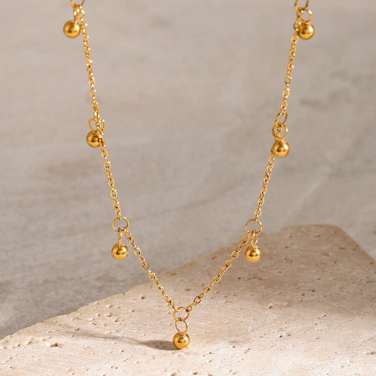 Delicate 18K gold necklace featuring light, round bead design, offering a minimalist and elegant look, perfect for adding a touch of sophistication to any outfit
