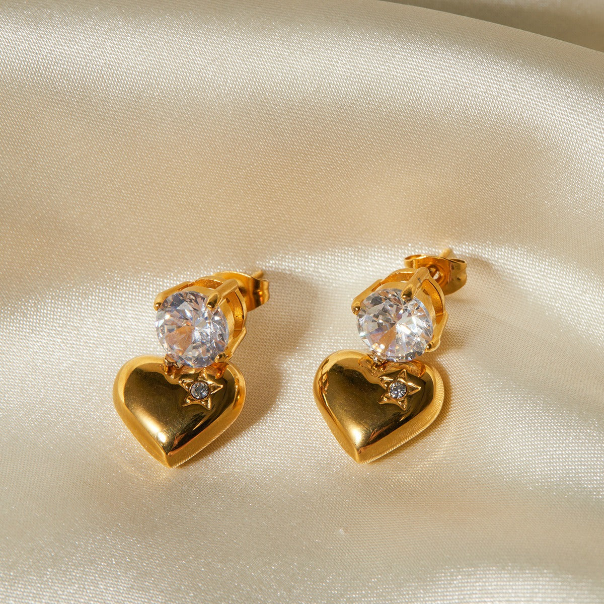 Elegant 18K gold heart-shaped earrings with sparkling inlaid zircon stones, combining luxury and charm for a sophisticated, timeless look
