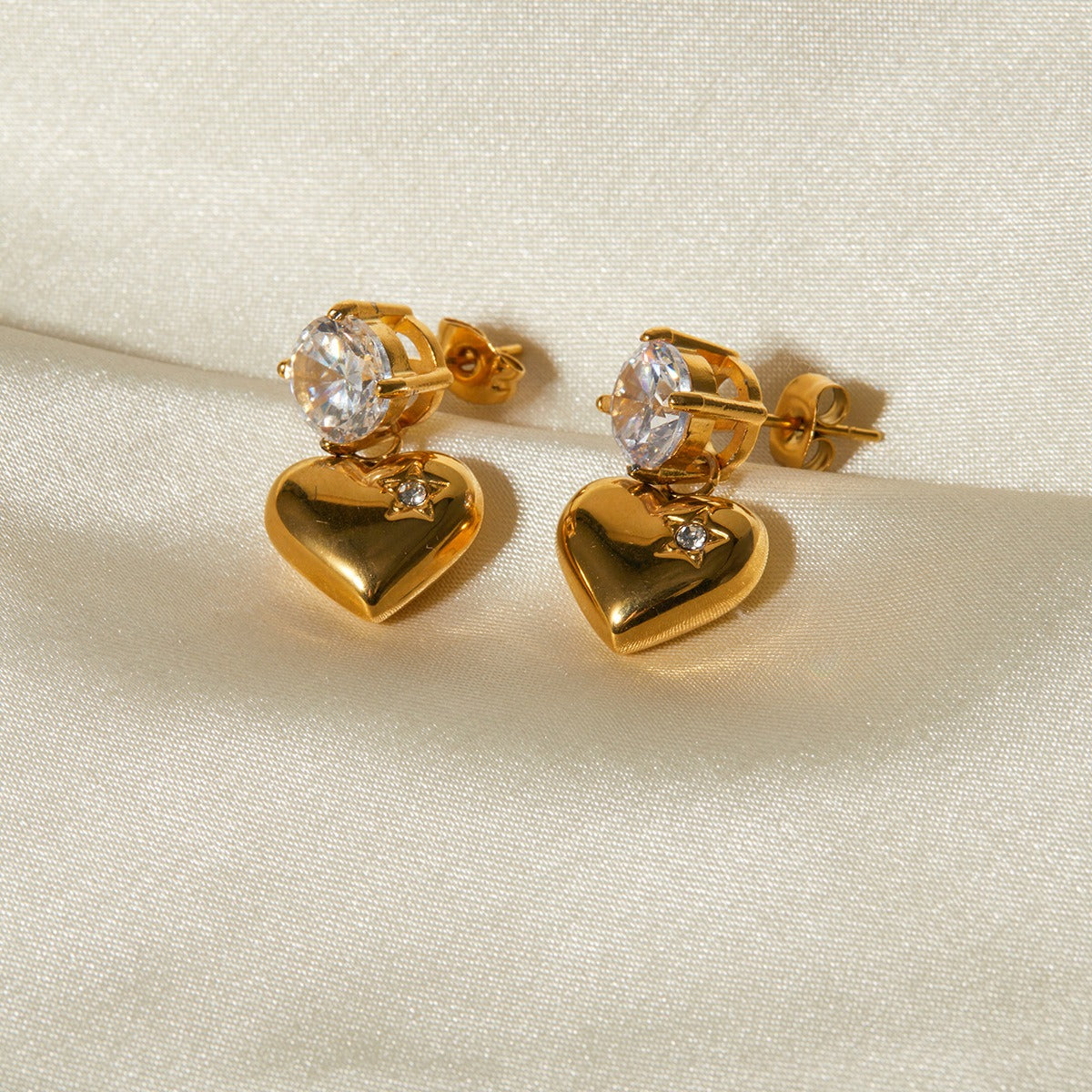 Elegant 18K gold heart-shaped earrings with sparkling inlaid zircon stones, combining luxury and charm for a sophisticated, timeless look