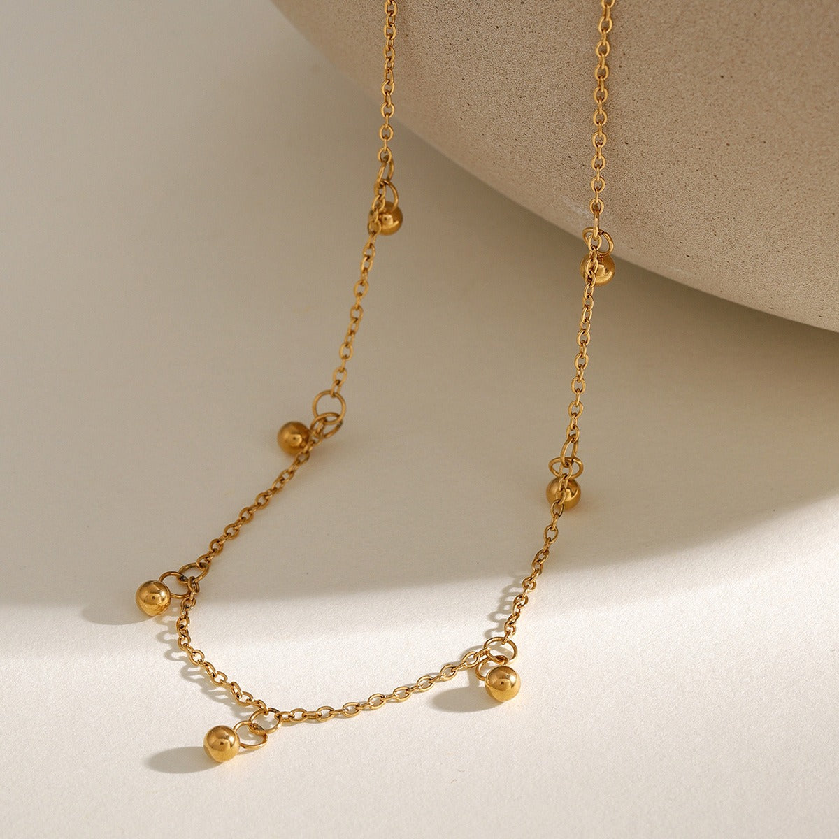 Delicate 18K gold necklace featuring light, round bead design, offering a minimalist and elegant look, perfect for adding a touch of sophistication to any outfit