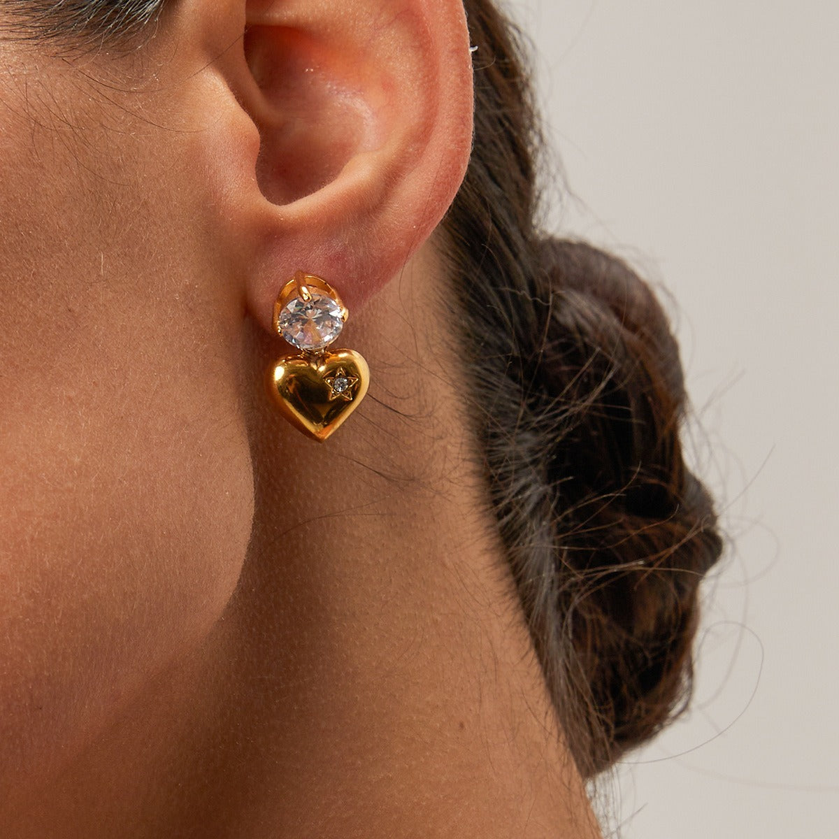 Elegant 18K gold heart-shaped earrings with sparkling inlaid zircon stones, combining luxury and charm for a sophisticated, timeless look