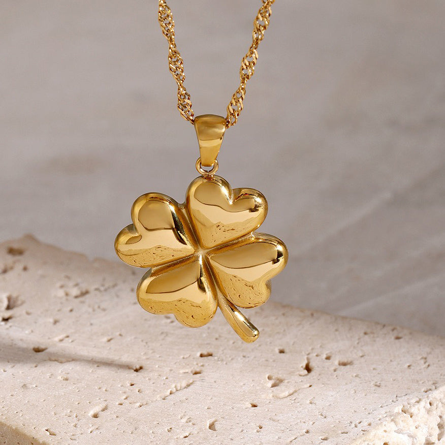 Elegant 18K gold pendant necklace featuring a delicate four-leaf clover design, symbolizing luck and fortune, with a shiny gold finish that adds a touch of luxury and charm.